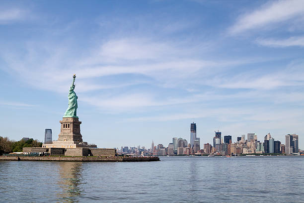 istock Statue of Liberty, and Manhattan Skyline behind it 178425974