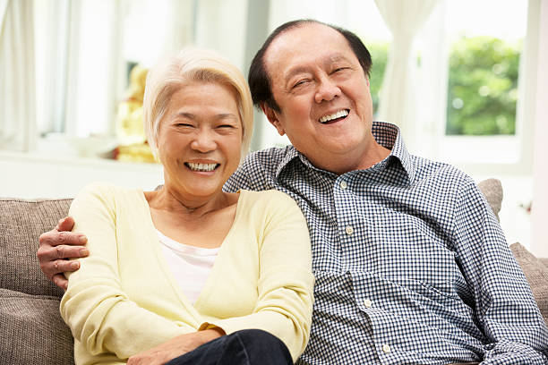 istock Senior Chinese Couple Relaxing On Sofa At Home 178426091