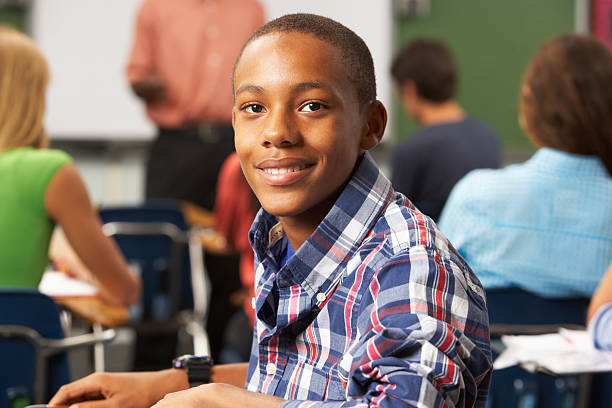 Young male student in a full classroom