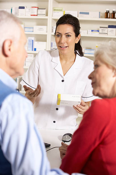 istock American pharmacist dispensing to senior couple 178426258