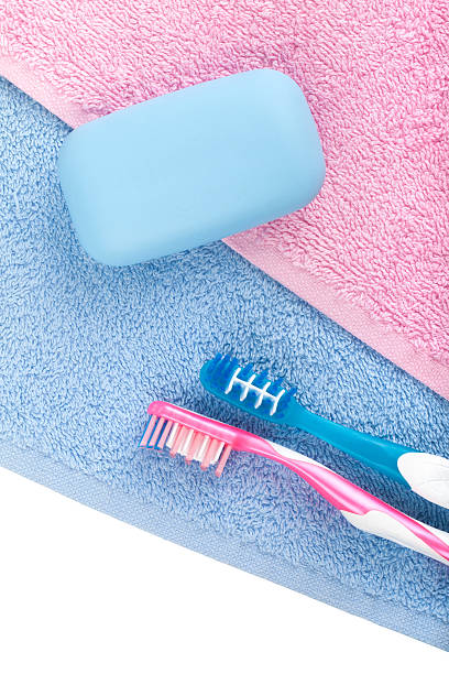 istock Toothbrushes and soap over towel 178426447