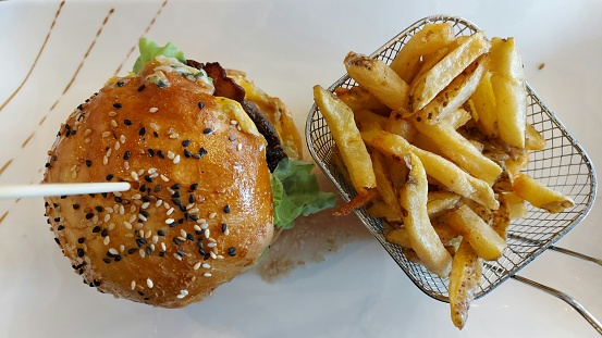 burger with ground beef, lettuce and French fries