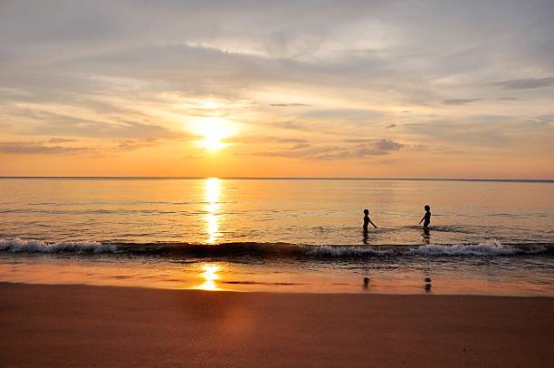 istock Children fun and happy on the beach under sunset light 178426827
