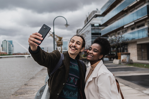 Young couple taking a selfie in Puerto Madero, Buenos Aires