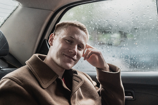 Portrait of a young man in a taxi