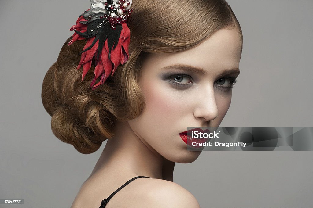 Woman with makeup and hairstyle Portrait of attractive young woman with red lipstick and  beautiful hairstyle. Hairdo with beautiful hair decoration Adult Stock Photo