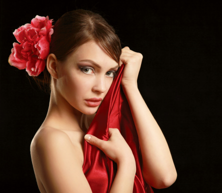 Young woman on red dress, isolated on black background