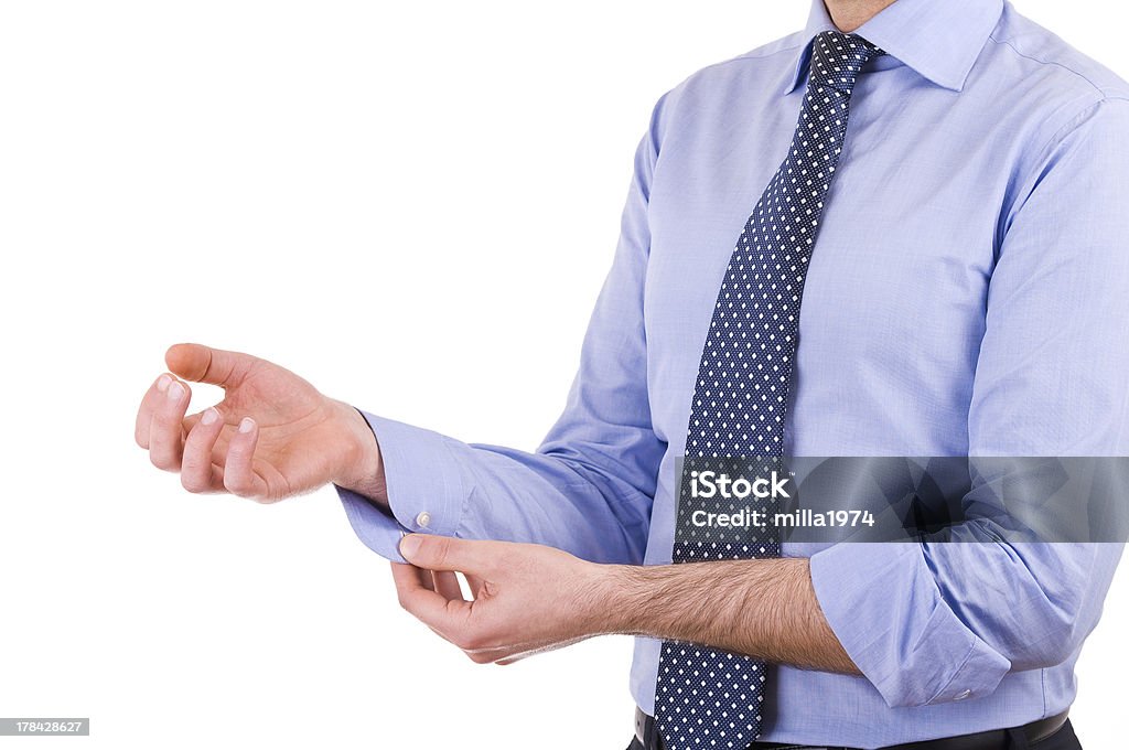 Businessman rolling up his shirt sleeves. Leadership Stock Photo