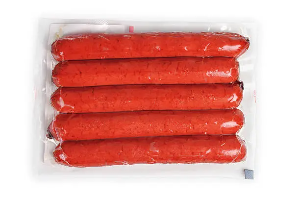 a pack of raw sausages on a white background