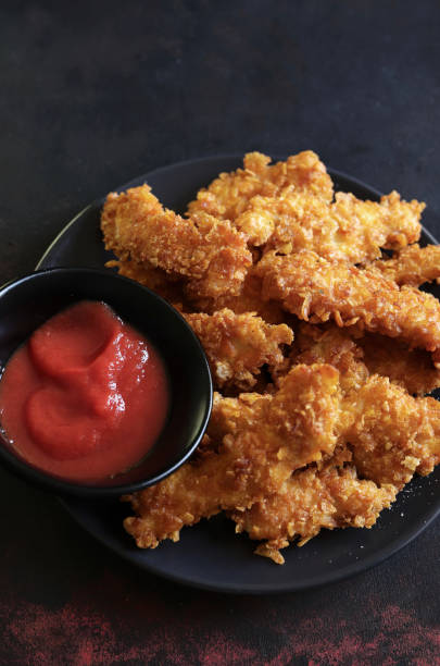 istock Baked chicken nuggets with ketchup. 1784291042