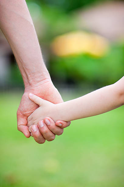 istock Father and daughter holding hands 178429320