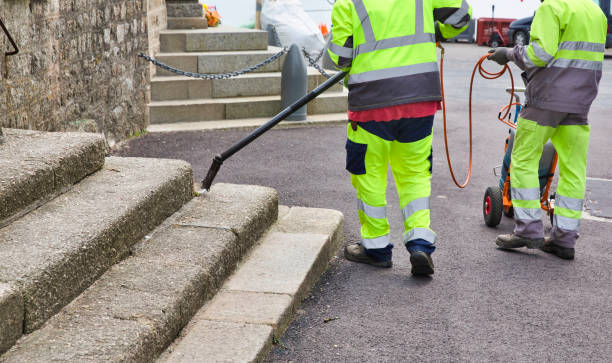 istock Two men burning weeds with gas in street. Environment respect 1784296593