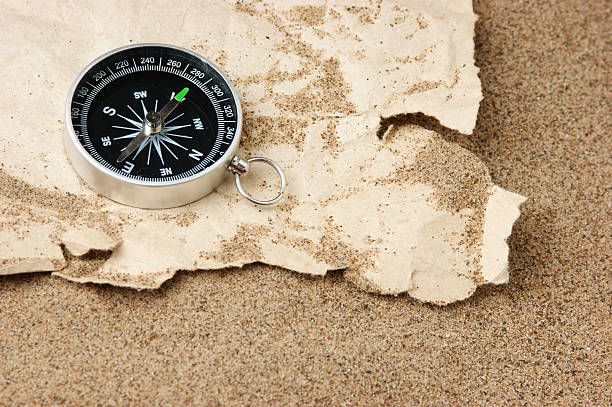 istock Compass on old sheet paper against the background of sand 178430202