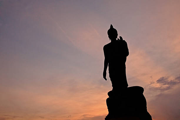 istock Silhouette of Buddha statue with ray light at twilight 178430385