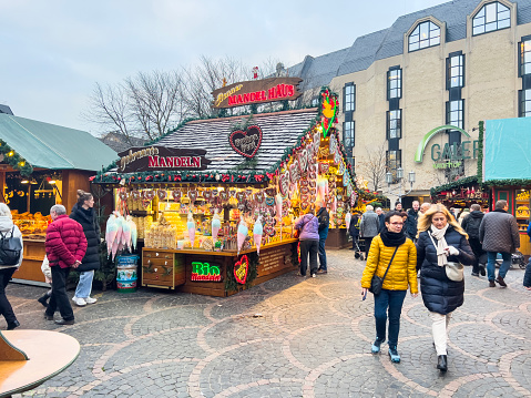Bonn, Germany, 12/01/2022: Happy people shopping in Christmas Market shops.