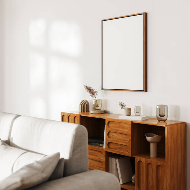 istock Blank picture frame mock up above wooden cupboard with decor on white wall with sunlight, gray sofa, modern living room interior, 3d 1784312297
