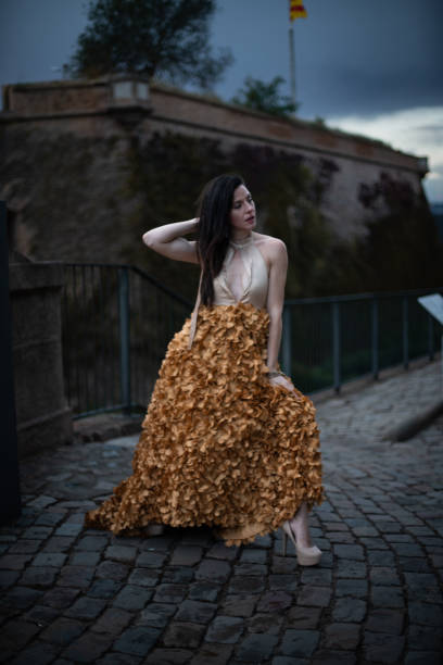 istock Woman in Elegant Dress on a Castle at Susnet. 1784315568