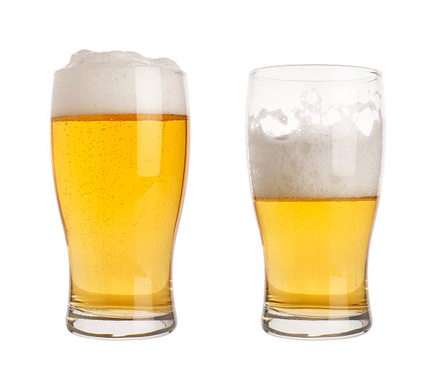 glass of beer with clippin path two glasses of beer, one half empty, one full. isolated on white with clipping path half full stock pictures, royalty-free photos & images