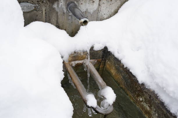 istock Regulated natural spring or source of water arranged into a fountain in winter captured in high angle view. 1784318443