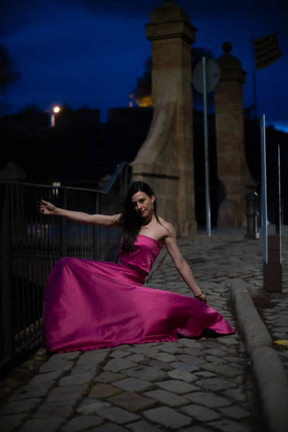istock Woman in elegant dress on a castle at night 1784319528