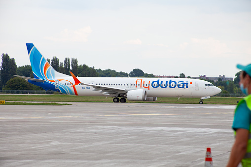 Passenger plane FlyDubai airlines Boeing 737 MAX 9, A6-FNA. Airport apron planes. Aircraft on runway. Airplane arrives. Ukraine, Kyiv - September 1, 2021.