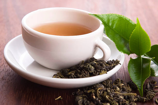 istock cup of green tea with freh leaves 178432078