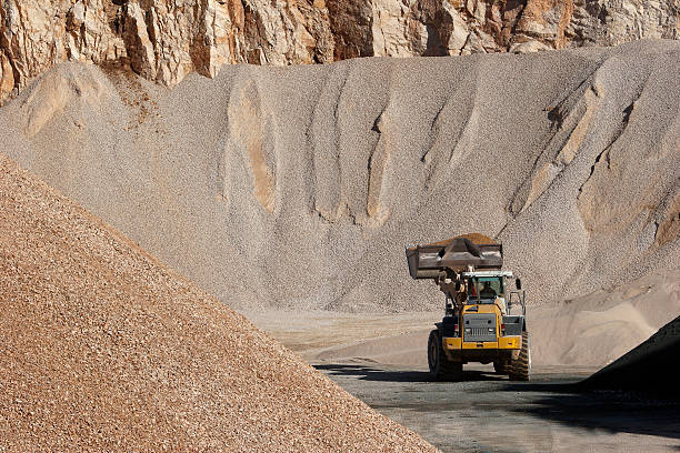Dumper truck and earth mover in a mining pit, Venezuela
