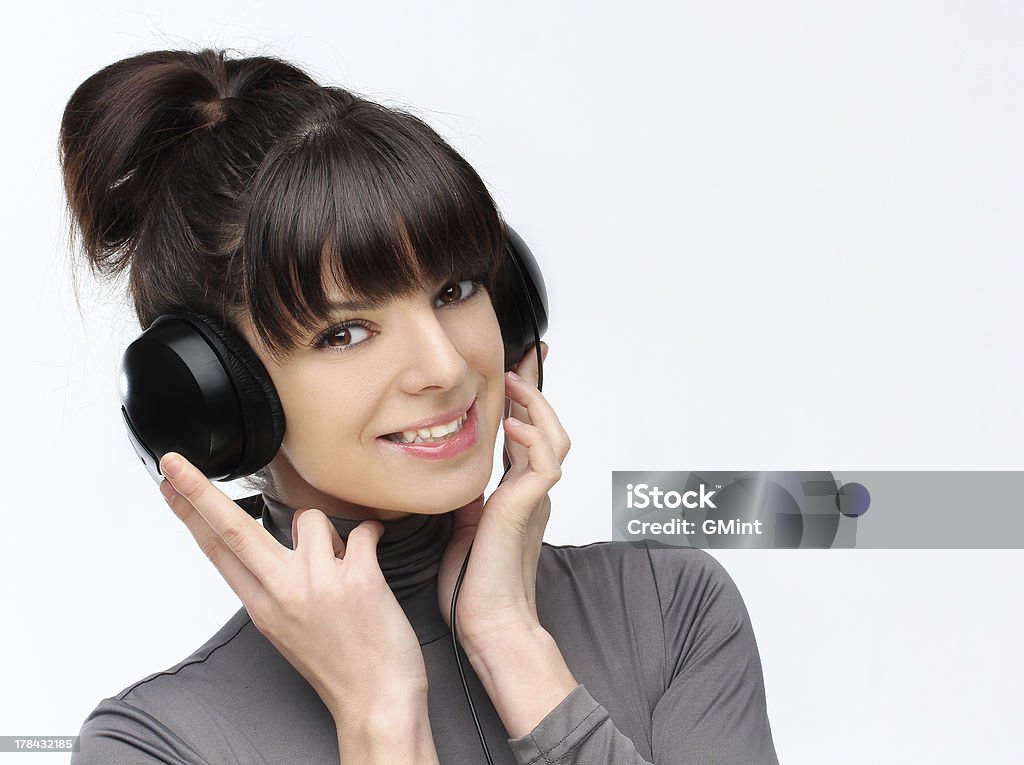 Happy young woman listening to music with a headphone. Adolescence Stock Photo