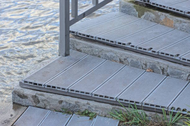 istock gray old metal steps in green grass with iron handrails on the shore 1784326236