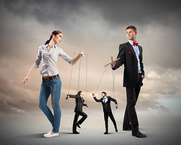 istock Businesspeople with marionettes 178432645