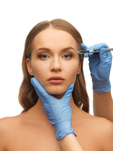 istock woman face and beautician hands 178432848