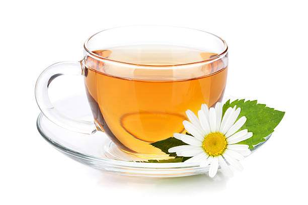 Cup of tea with mint leaves and chamomile flower Cup of tea with mint leaves and chamomile flower. Isolated on white background chamomile plant stock pictures, royalty-free photos & images