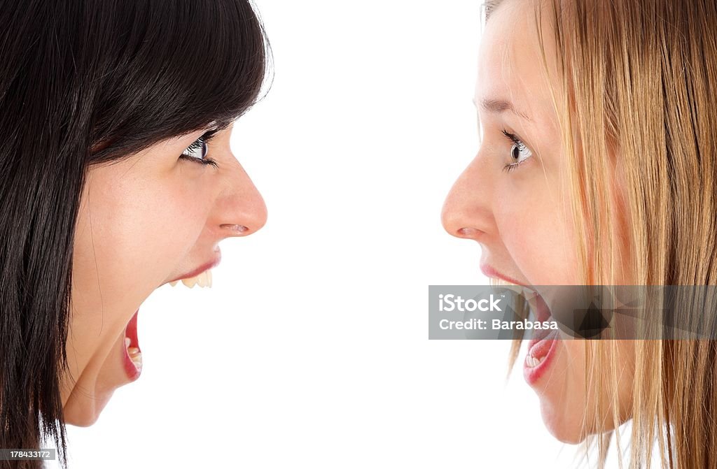 Girl hysterics Close-up of young friends shouting at each other. Adolescence Stock Photo