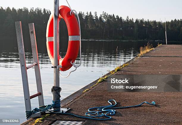 Safety Equipment Bright Red Lifebuoy On The Pier Stock Photo - Download Image Now - Assistance, Buoy, Circle