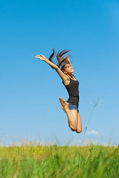istock beautiful young woman jumping up 178433392