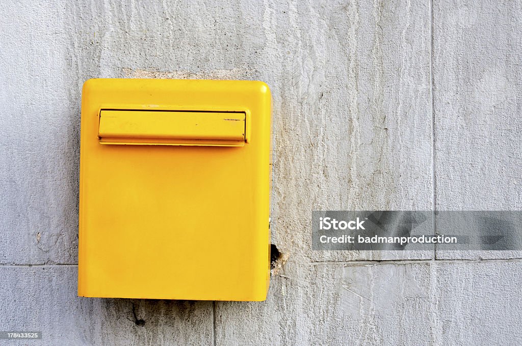 Yellow postbox Yellow postbox on the wall Architectural Feature Stock Photo