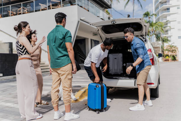 istock Friends talking while putting suitcases in car trunk 1784336950