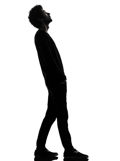 istock handsome african young man standing looking up surprise silhouette 178433954