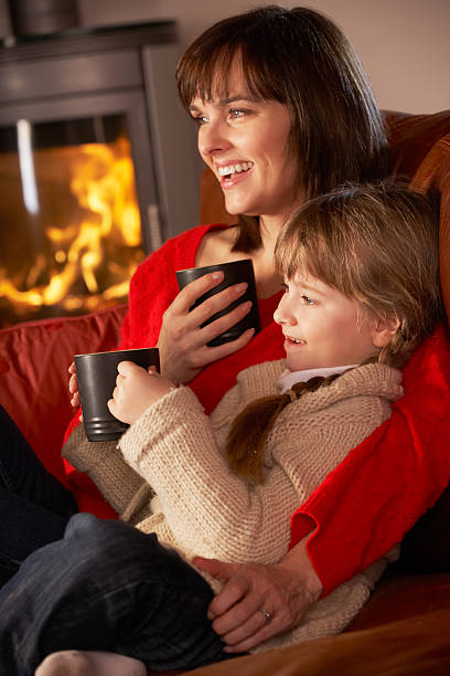 istock Mother And Daughter Relaxing With Hot Drink Watching 178434927