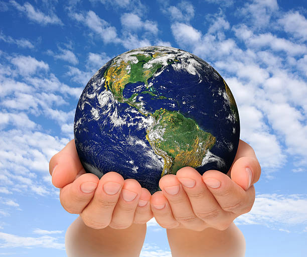 Woman holding globe on her hands, South and North America stock photo