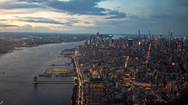Aerial shot of the New York City skyline and the Hudson river at dawn.