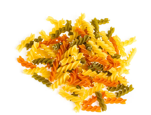 istock Uncooked pasta fusilli in different colours, white background 178435882