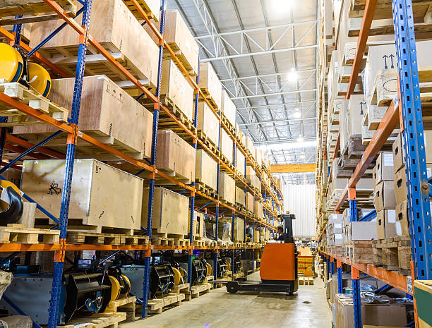 Large modern warehouse with forklifts stock photo