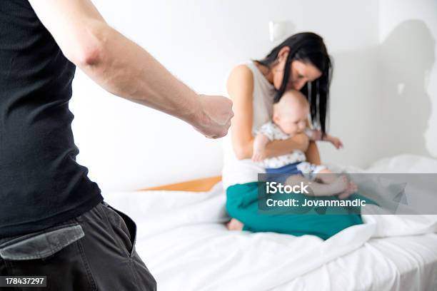 A Young Woman And Her Baby Frightened By A Violent Man Stock Photo - Download Image Now