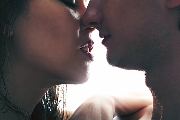 istock A couple kissing with the sun bright behind 178437894