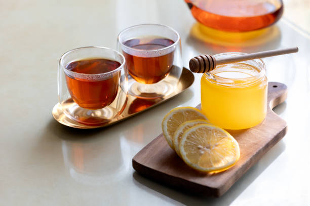 istock Healing warm tea with honey and lemon at home table 1784384031