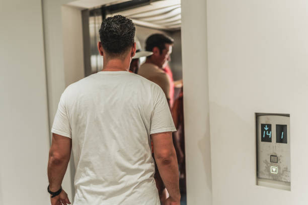 Rear view of a man entering in elevator at hotel