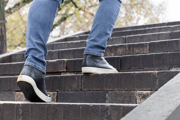 istock man climbs stone stairs in the park. 1784384821