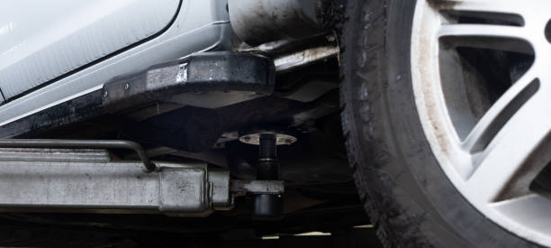 istock Off-road vehicle close-up on lift in garage 1784384926