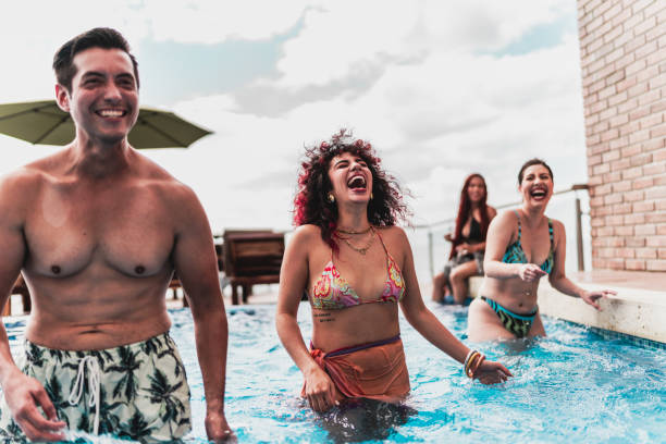 istock Friends talking in the pool at hotel 1784385433